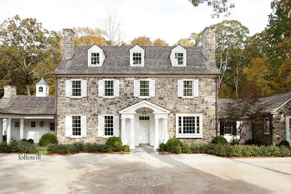 Colonial Home with Stone Exterior and White Shutters