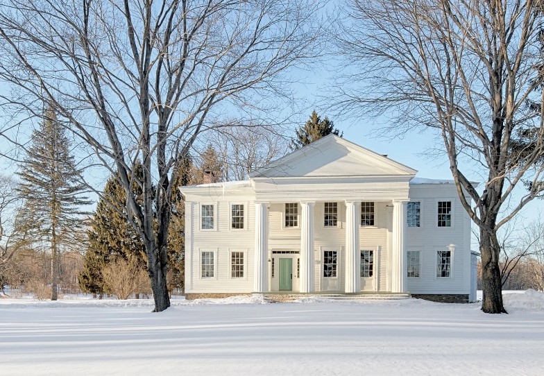 Beautiful white Greek Revival Home in winter setting